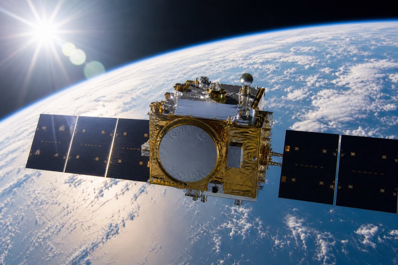 Earth observation satellite in orbit above Earth with bright dramatic lighting