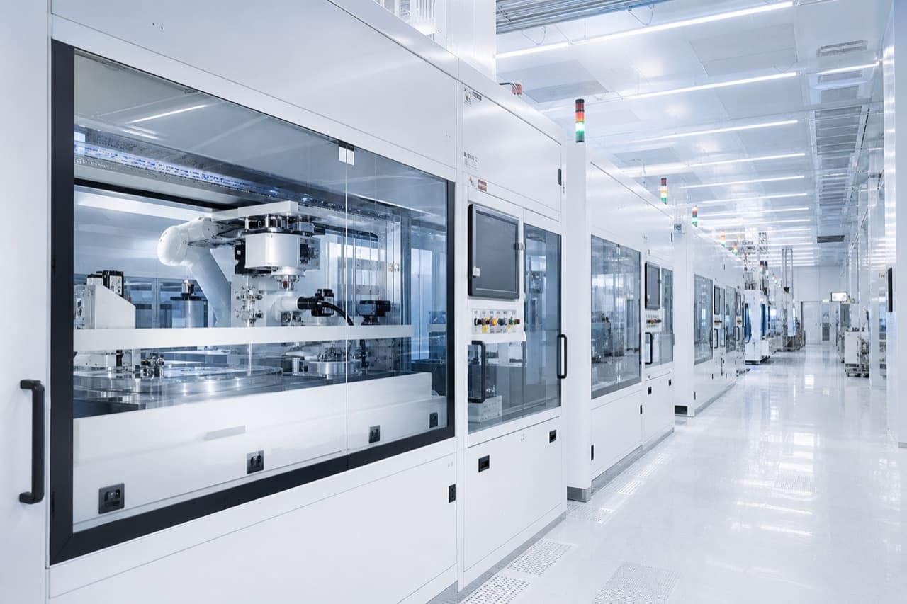 Precision manufacturing equipment in a cleanroom with cool blue lighting